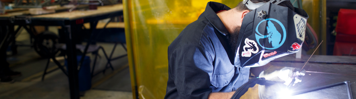 a student welds to pieces together