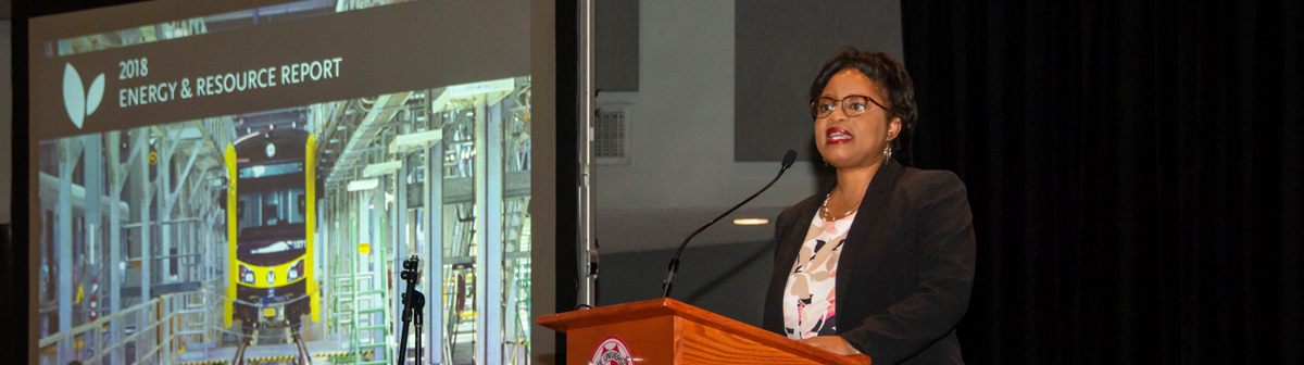 a woman speaks at a podium for energy research