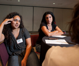 students listen intently as a woman speaks to them