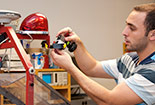 Student working on a machine.