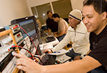 Student pushing buttons on a device.
