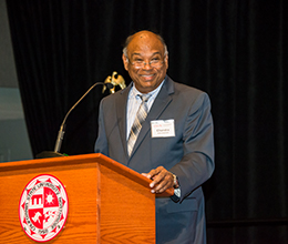 The dean of the college of business speaks at an event