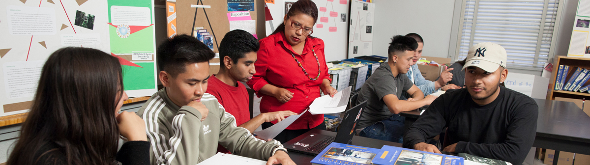 a teacher in her classroom helps her students