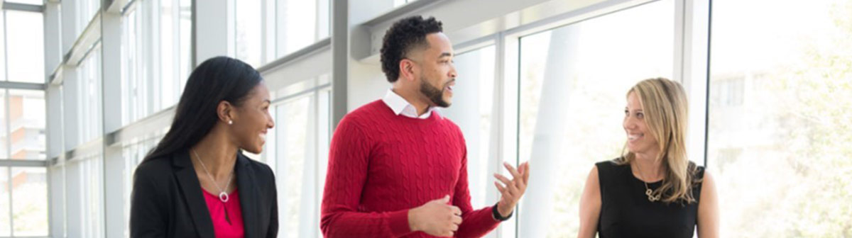 students listen intently as a man speaks to them