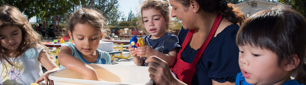 A child is attended to by two women