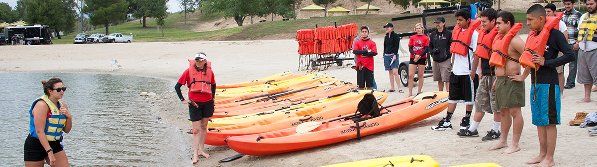 Two students help a man with his aquatic therapy 