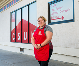 a worker poses for a picture outside of the CSUN food pantry