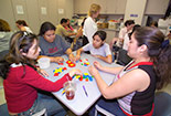 Adults and Children sitting together at a table.