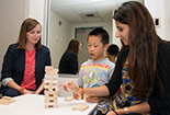 CSUN Professionals working with a child