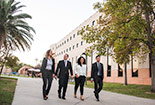 Four students walking outside together.