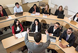 A Professor talking to students in front.