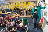 Students in a classroom being taught by a teacher.