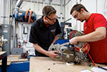 Students in a shop using machinery.