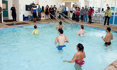 People in pool doing an activity.