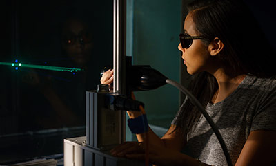 Students using a laser equipment.