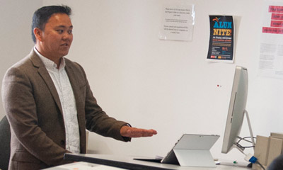Professor Teaching at desk.