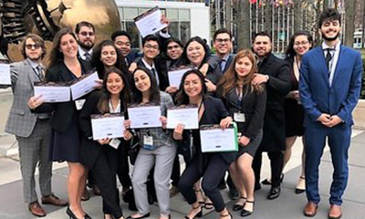 Students of Model United Nations smiling with thier awards.