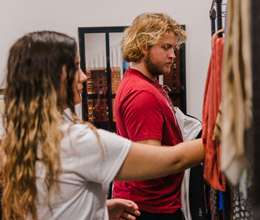 A female and male student browse clothes.